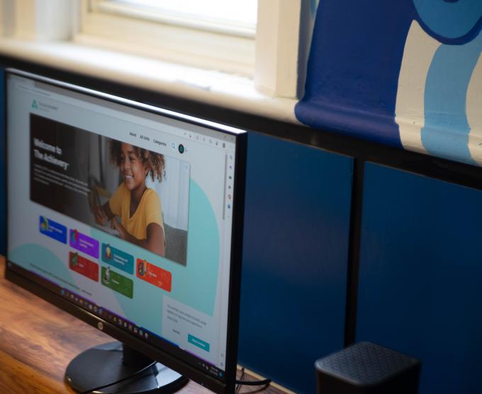 Photograph of a computer desktop in an office.