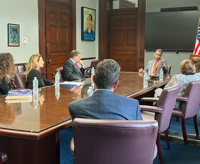 Photograph of a meeting taking place in a conference room at Rochester City Hall.