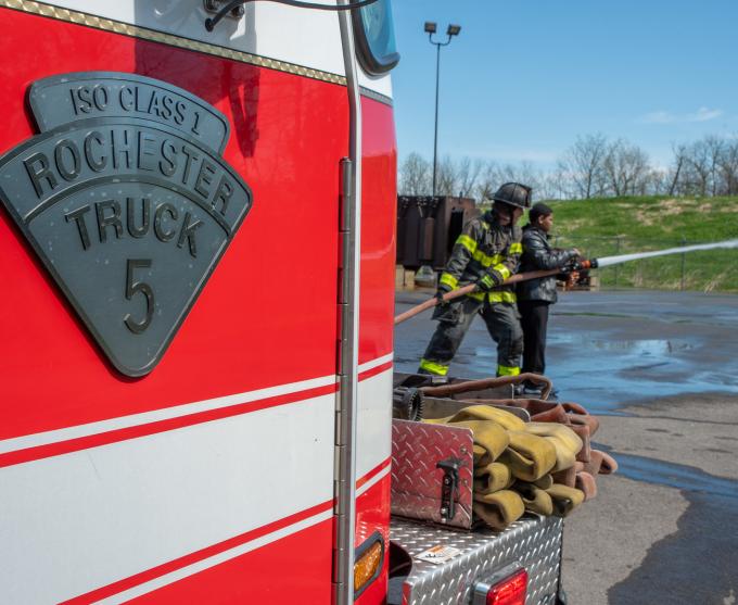 Photo of a Rochester fire truck and a a Rochester firefighter