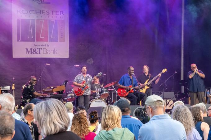Photo of a band playing on a stage at the 2023 Rochester Jazz festival