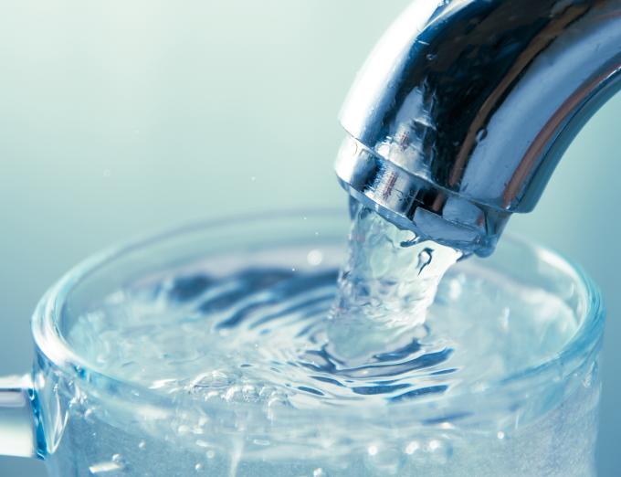 Photo of water filling a glas.